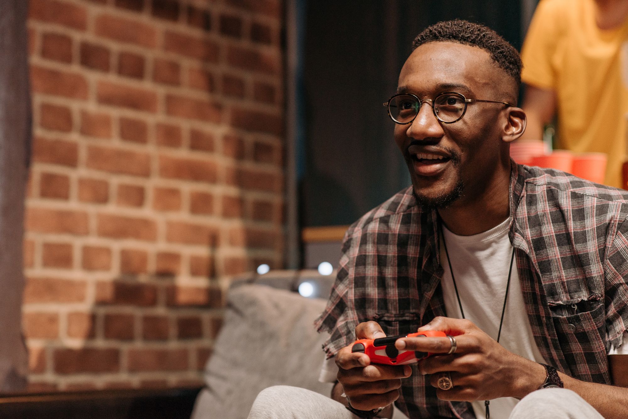 A black man holding a game controller