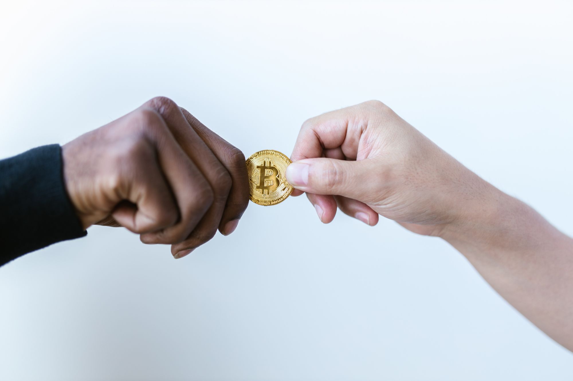 Two people exchanging a bitcoin