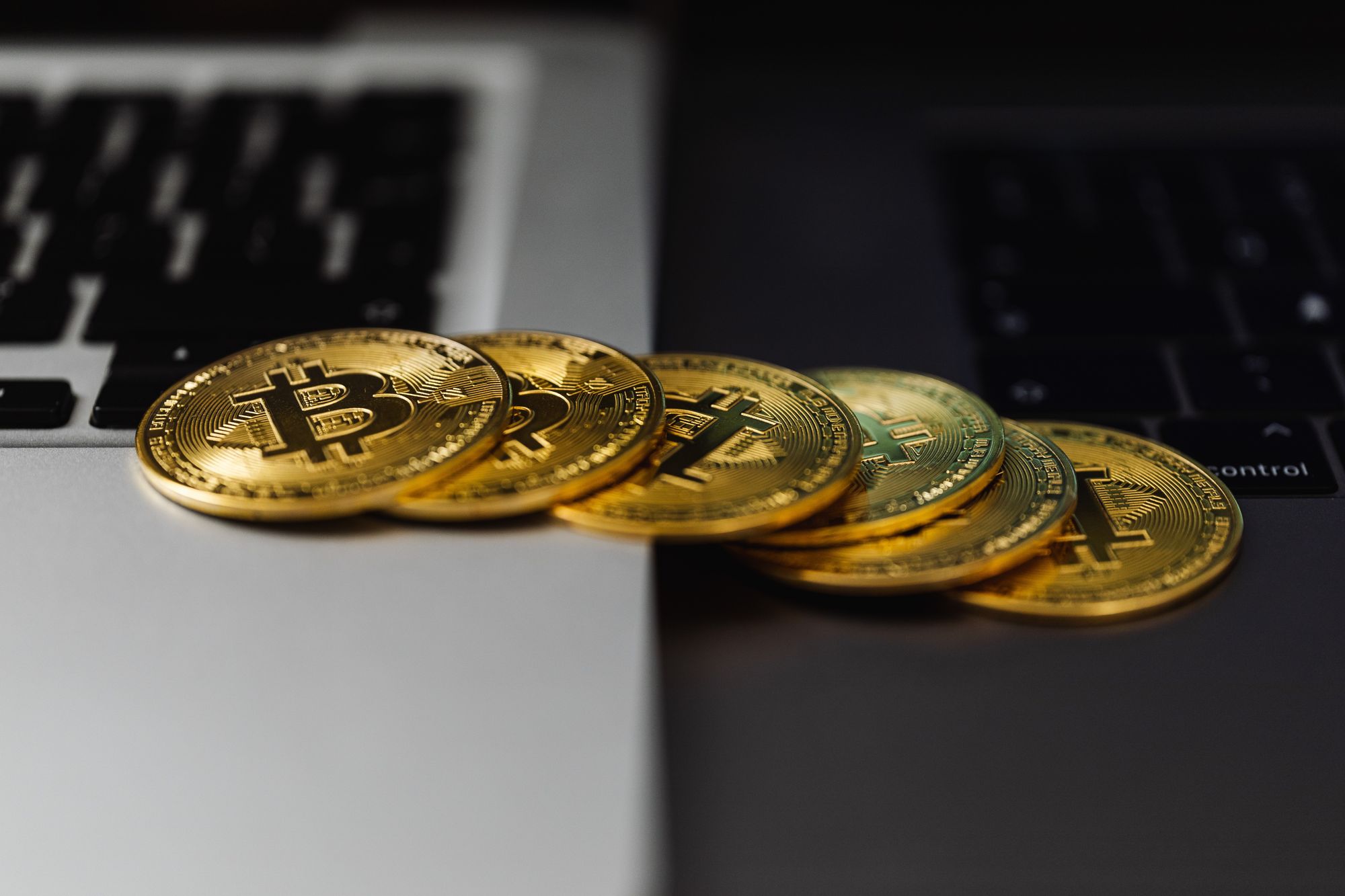 bitcoins spilling from one laptop to another