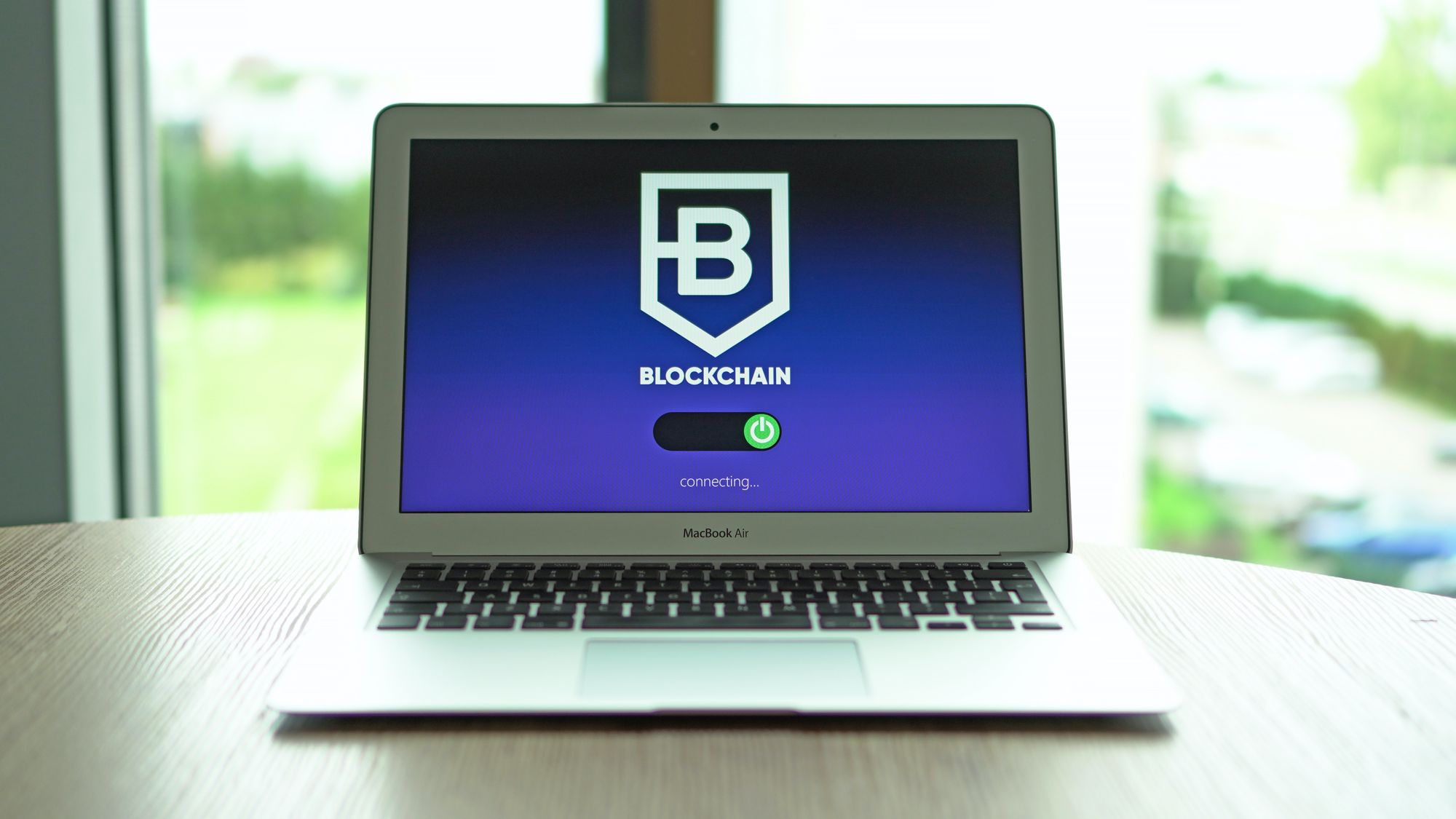 An open macbook with blockchain written on the screen