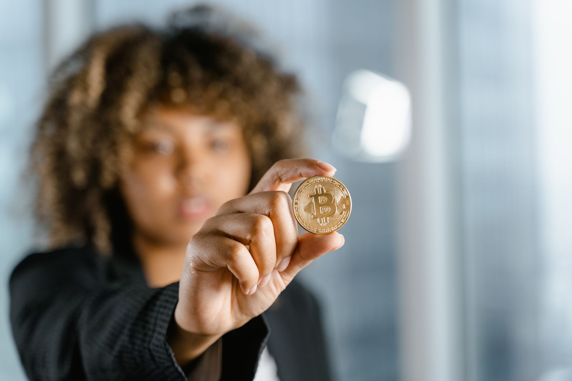 A woman holding a bitcoin