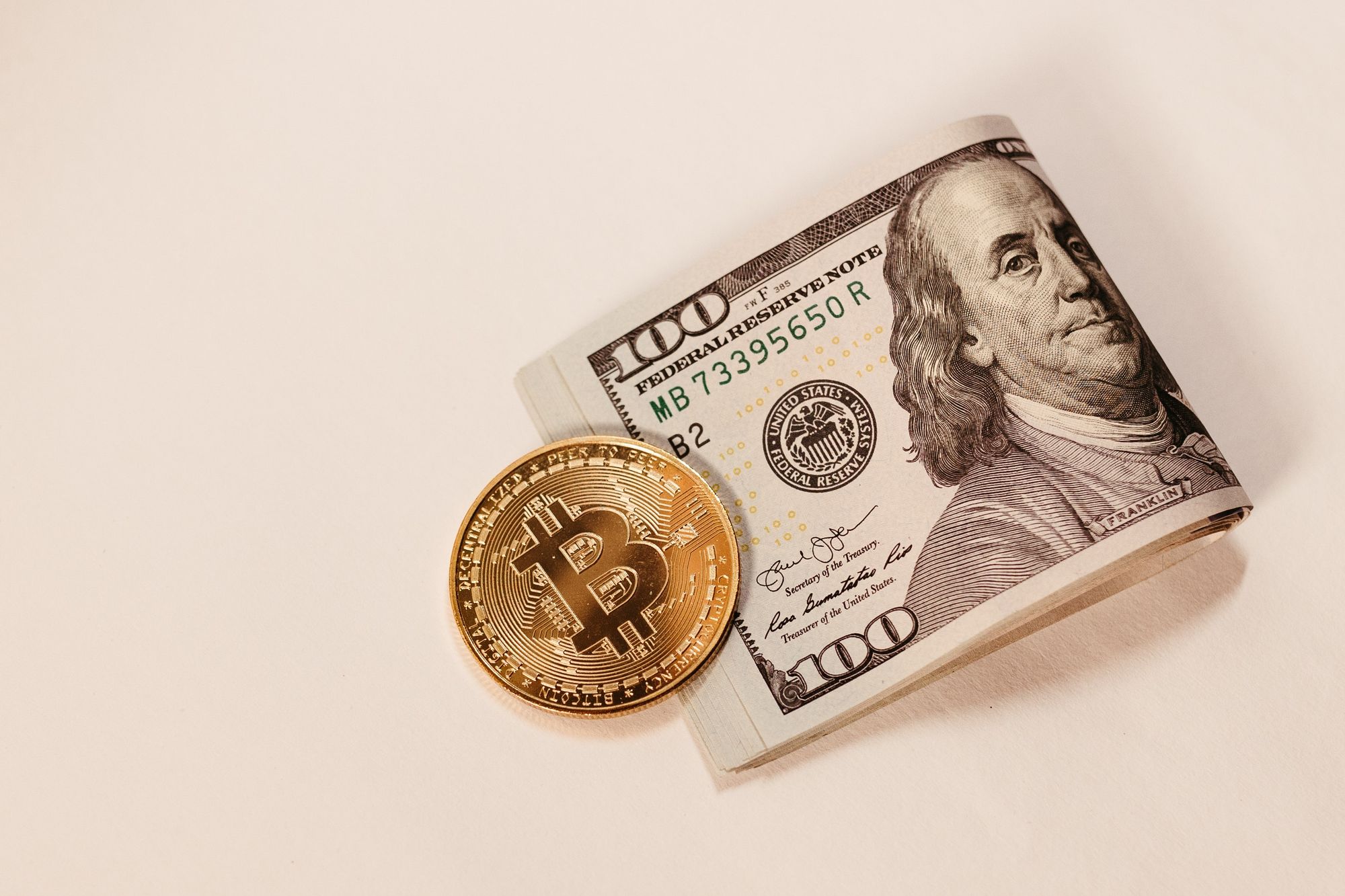 Bitcoin and a 100 Dollar note